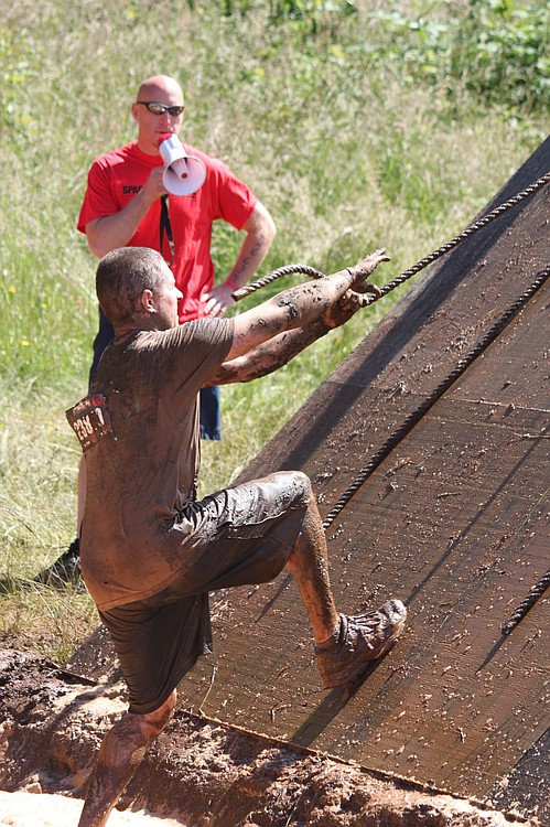 Participants had to run through a pool of soapy water before taking on this wall climb obstacle.