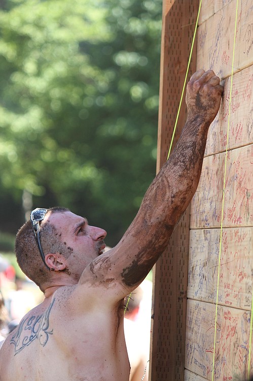 Spartan Race finishers sign the &quot;Wall of Fame&quot; after completing the extreme obstacle course race on Saturday, July 16, at Washougal Motocross Park.