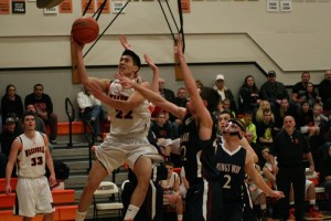 Austin Tran threads the needle around the Knights and weaves a basket for the Panthers Monday, at Washougal High School. The Panther boys and girls teams swept King's Way Christian in a doubleheader.