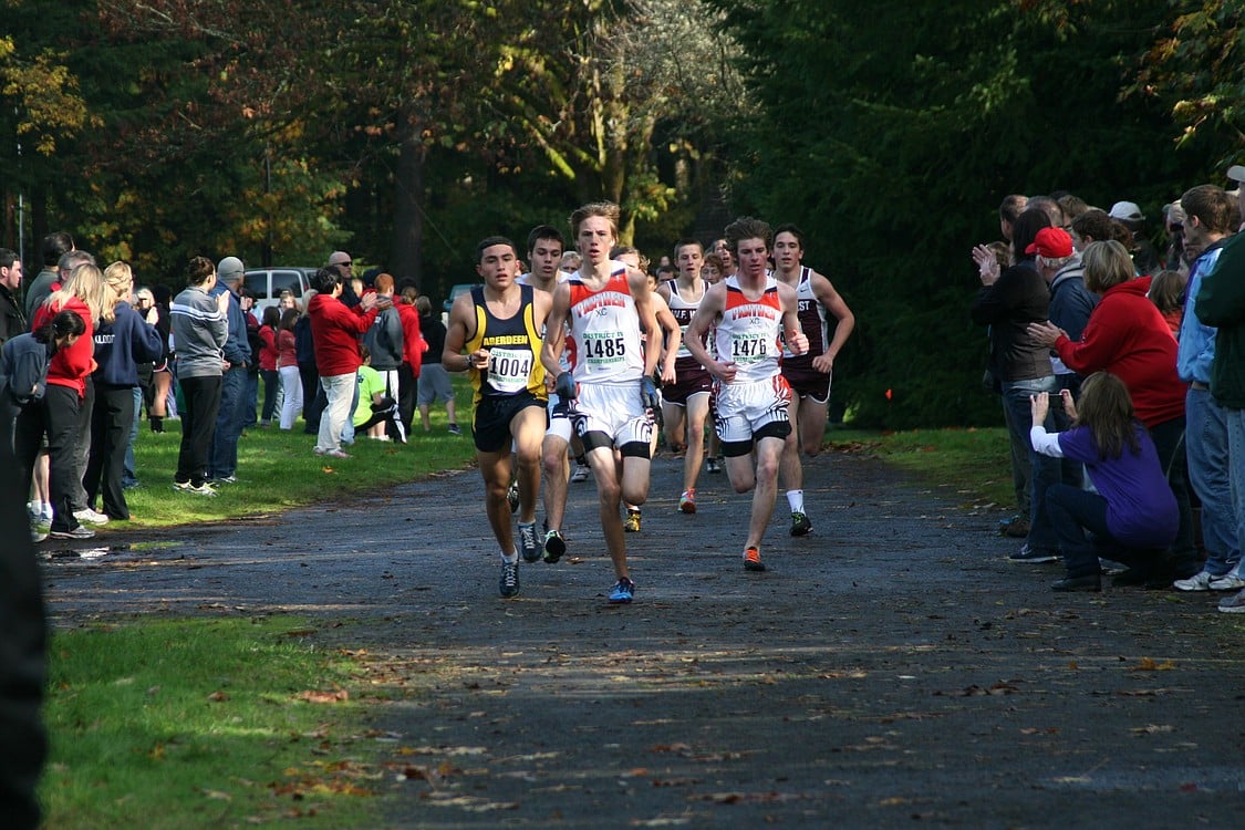 The crowd cheers on the runners.