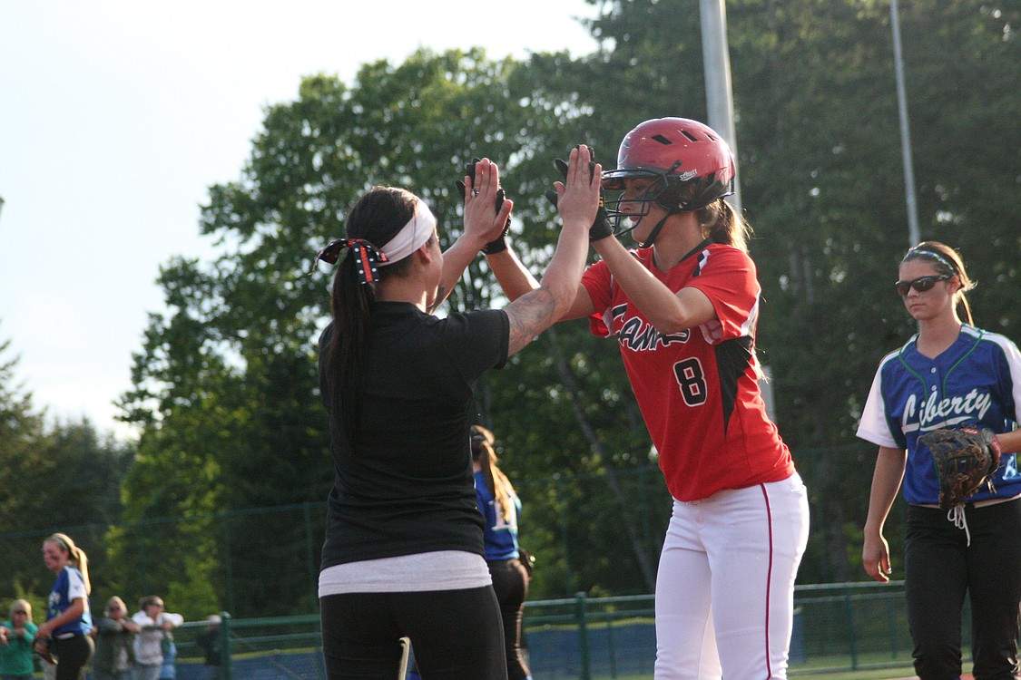 Cali Mulholland high-fives assistant coach Ari Van Horn.