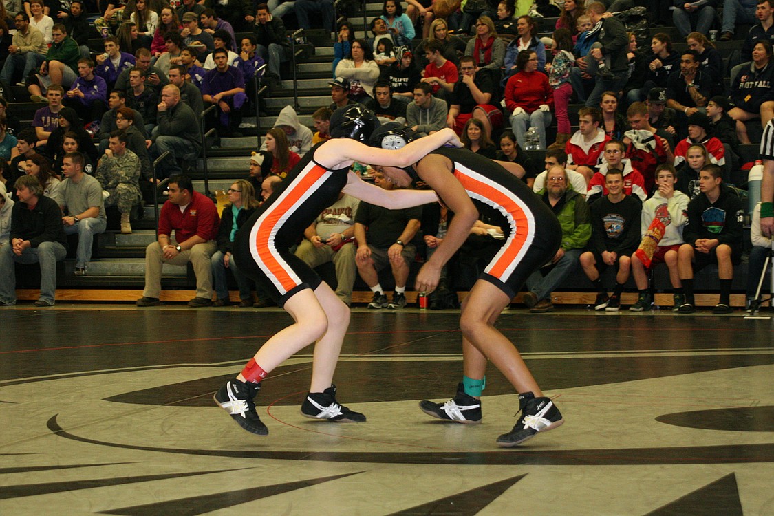 Washougal wrestlers Jessica Eakins (left) and Emily Alder-Storm (right) kick off the Clark County championship finals.