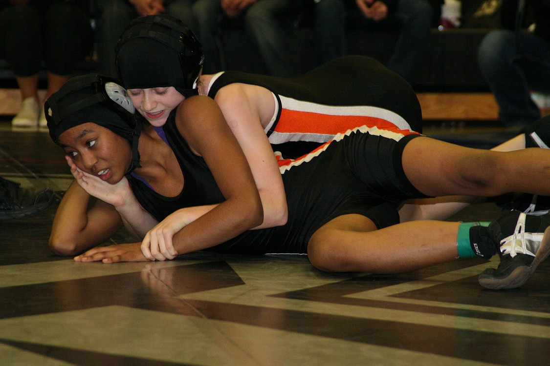 Jessica Eakins (top) and Emily Alder-Storm (bottom) tangle on the mat in the 100-pound championship finals, just like they do every day in the Panther jungle.