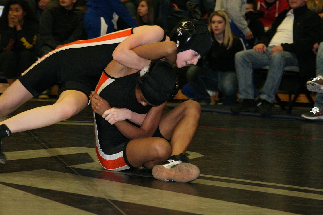 Jessica Eakins is about to wrap Emily Alder-Storm up for a pin. Eakins won the 100-pound county championship and Alder-Storm settled for second place.