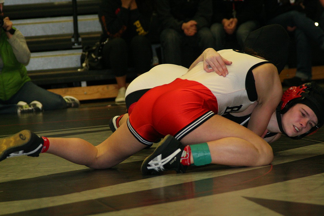 Camas wrestler Taryn Lommasson fights off the mat during the 106-pound championship match.