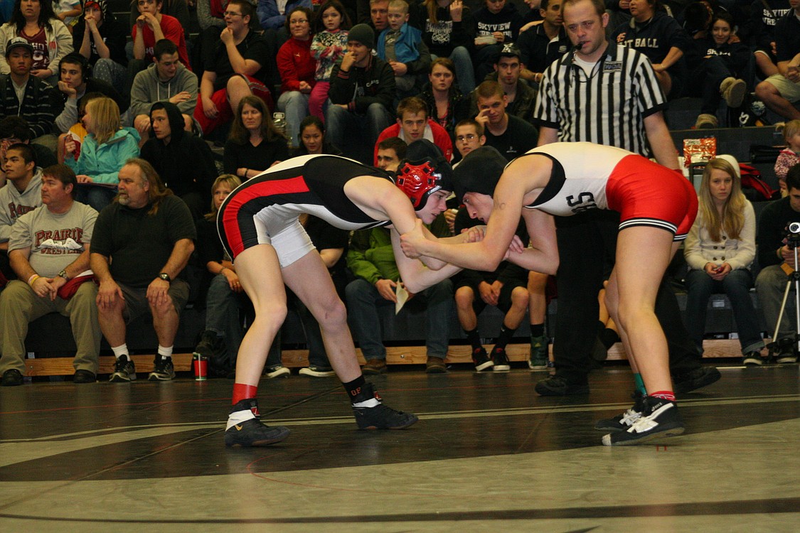 Taryn Lommasson (left), Camas, tangles with Kassi Strano (right), Battle Ground. Lommasson earned second place at 106 pounds.