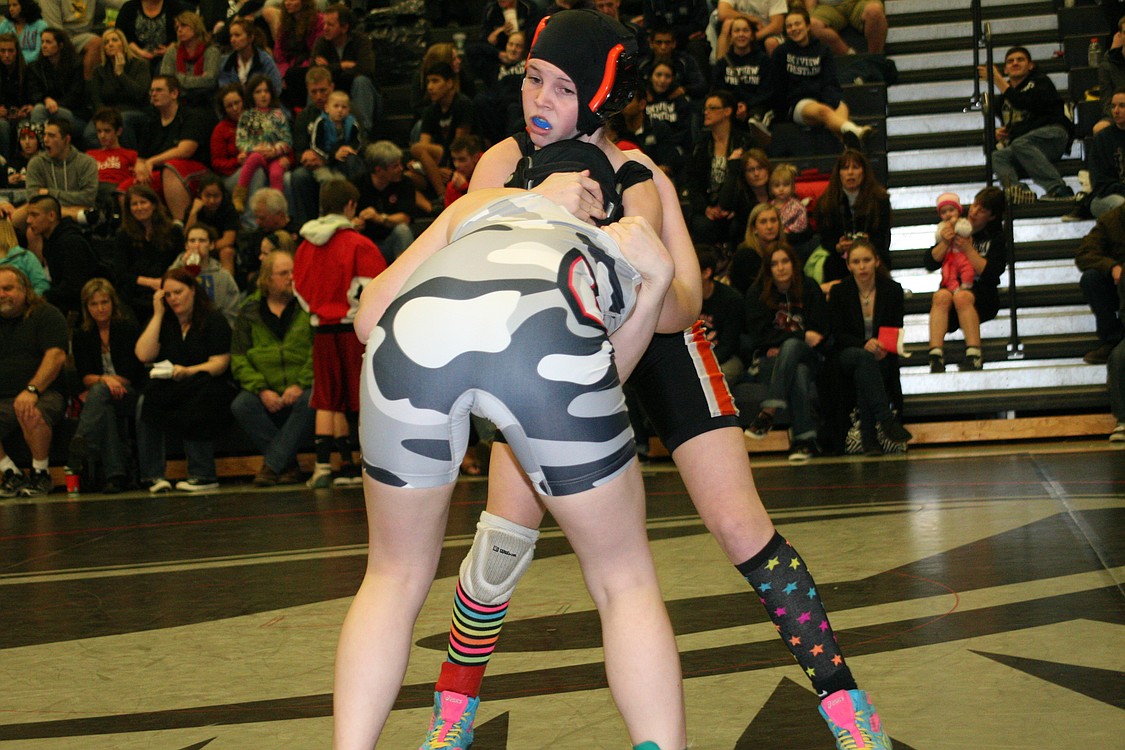 Washougal's Haven Camden headlocks Union's Kira Kelsey. Get a look at Camden's &quot;magic socks.&quot;