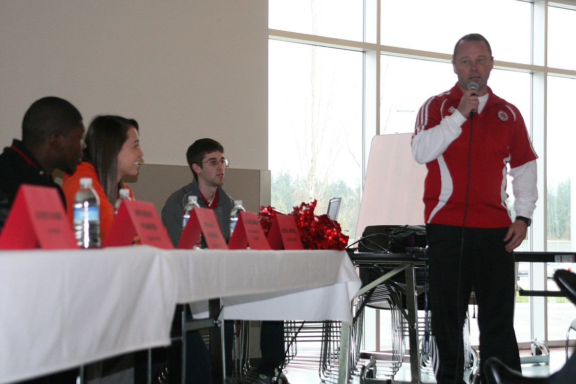 Camas soccer coach Roland Minder shares his memories with Emily Ainsworth, Michael Koceja and Olivia Lovell.