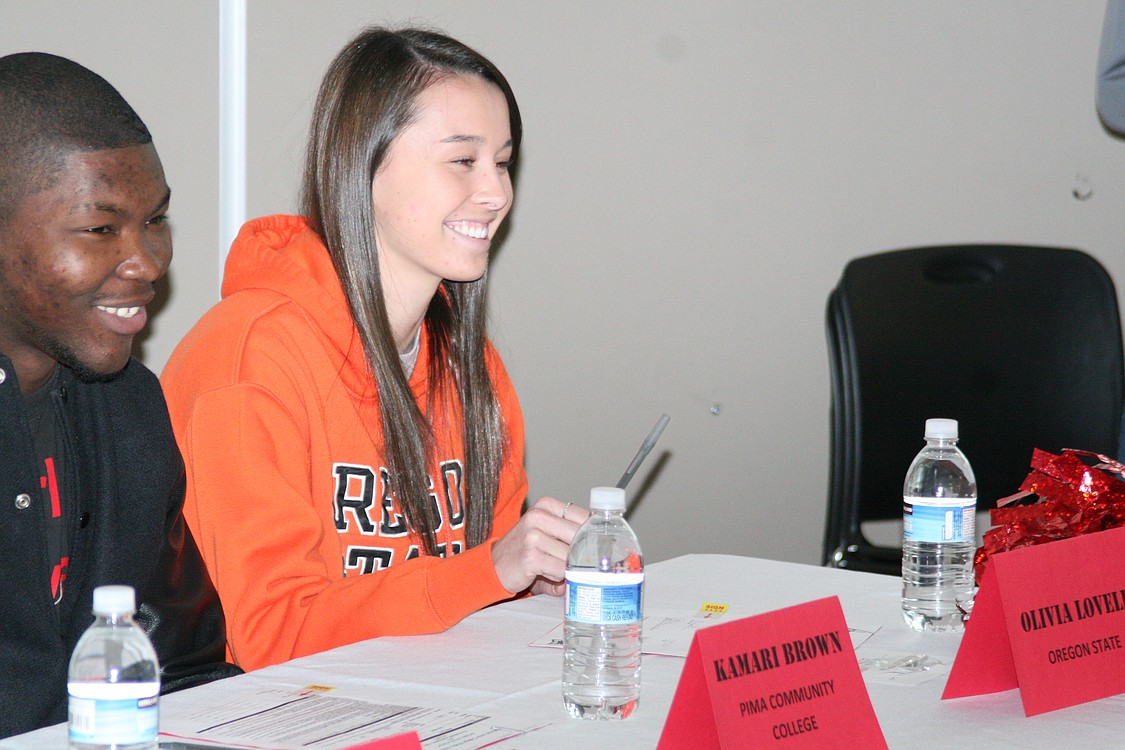 Olivia Lovell looks on with a smile after signing with Oregon State University.