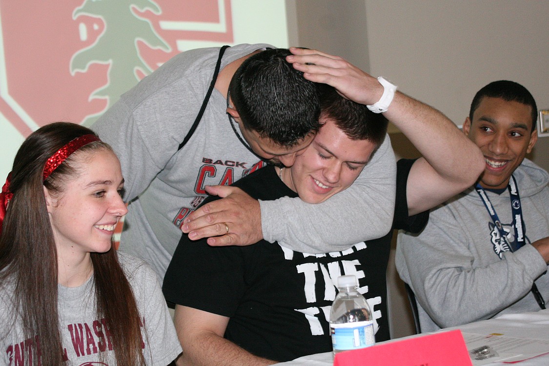 Camas baseball coach Joe Hallead gives Austin Barr a hug.