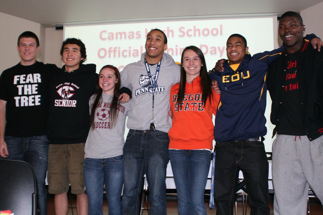 Left to right: Camas High School seniors Austin Barr, Michael Koceja, Emily Ainsworth, Jonathan Warner, Olivia Lovell, John Payne and Kamari Brown smile for the camera on National College Signing Day.