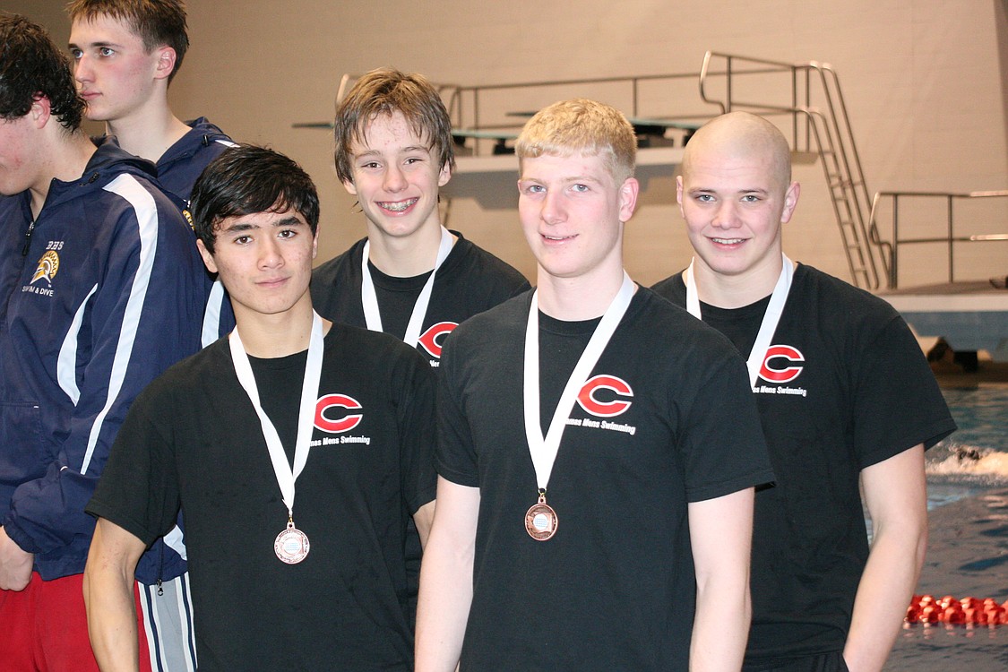 John Utas, Kasey Calwell, Nick Kabel and Jake Yraceburu (left to right) stand on the podium in seventh place after the 200 freestyle relay race.