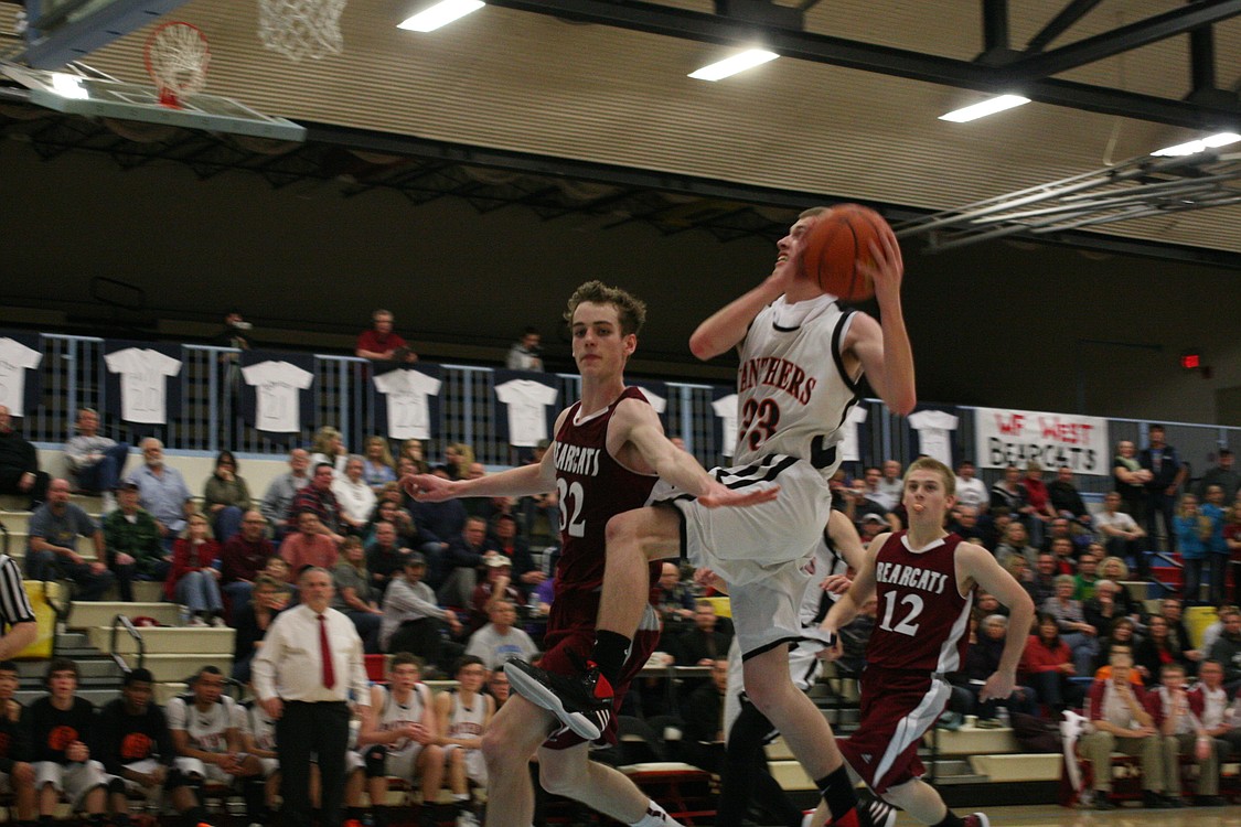 Jaden Jantzer takes the ball to the hoop for two points.