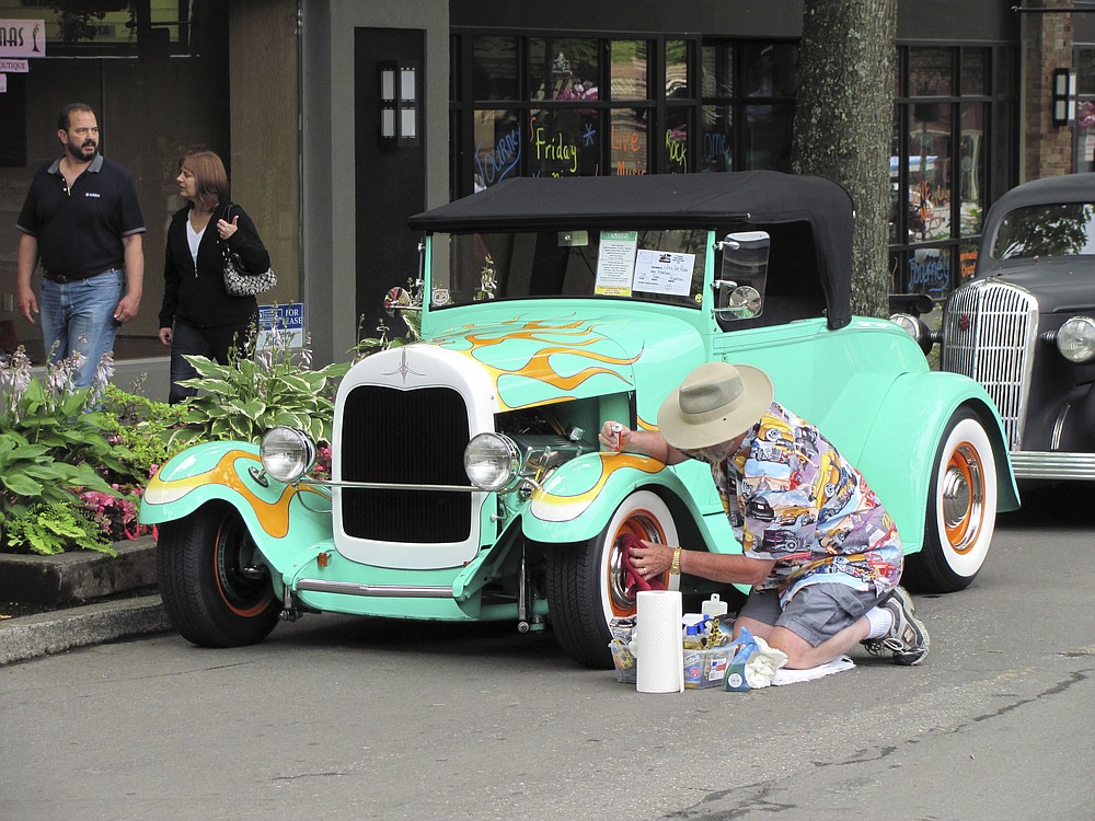 The wheels of the 1929 Ford Roadster owned by Jim and Gay Kane get a last-minute shine in preparation for the Camas Car Show on Friday.  The fifth-annual event, which included dozens of classic and specialty vehicle entries, was held on Northeast Fourth Avenue as part of the monthly First Friday activities. The event was sponsored by the 6th Avenue Commercial Center/Shell, Lacamas Community Credit Union, and is hosted by the Downtown Camas Association, Georgia-Pacific and Twilight Pizza Bistro. To view additional photos, visit the photo gallery at www.camaspostrecord.com.