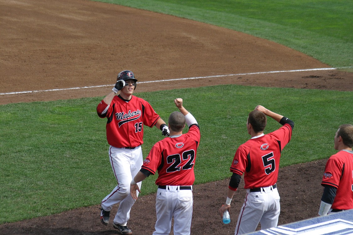 Austin Barr is congratulated by his teammates after doubling off the left field fence.
