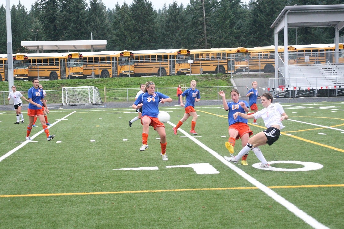 Kailee Esser curls the soccer ball around a couple of defenders for Camas and off the goal post Nov. 5, at Doc Harris Stadium. Janae Benson finished the deal, and the Papermakers headed back to state.