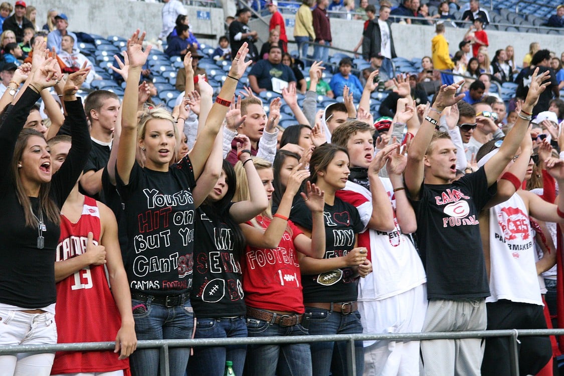 Camas football fans throw their hands up after performing the &quot;Hand Jive.&quot;