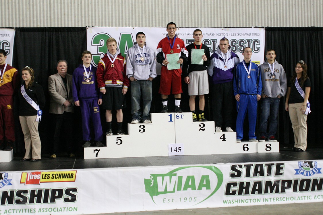 Miguel Salamanca stands on top of the podium as the Class 3A 145-pound state champion.