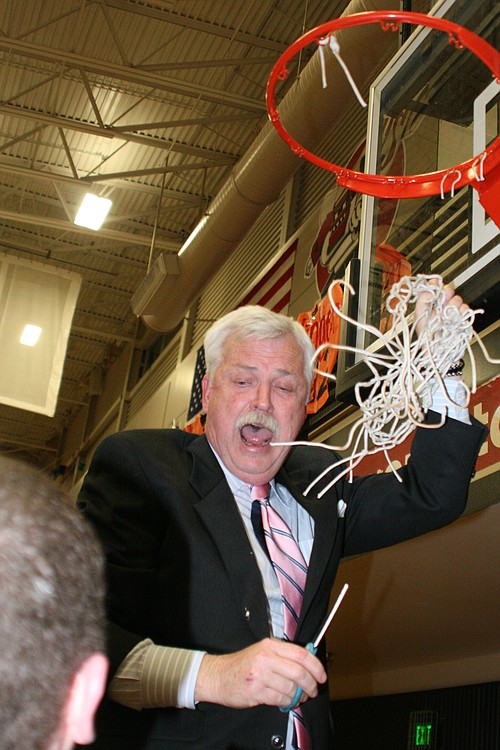 Coach Larry Crafton brings down the net.