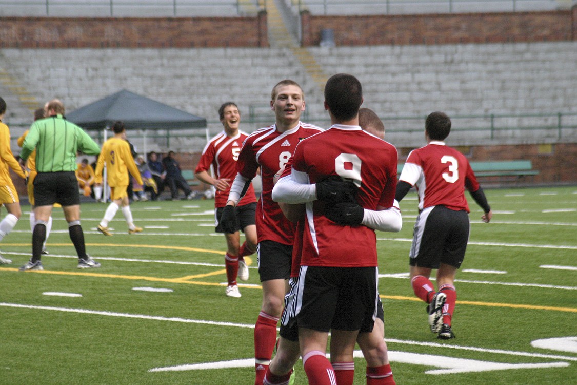 The Camas boys soccer players get fired up after scoring the first of four goals in the league championship game against Columbia River.