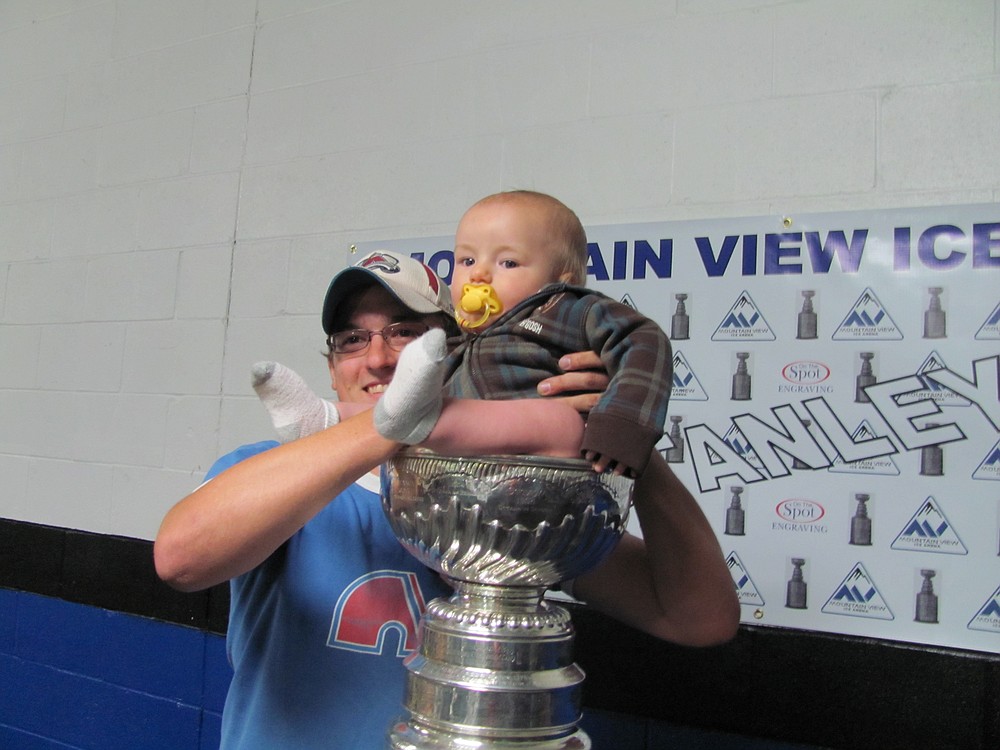 A baby sits in the Cup.