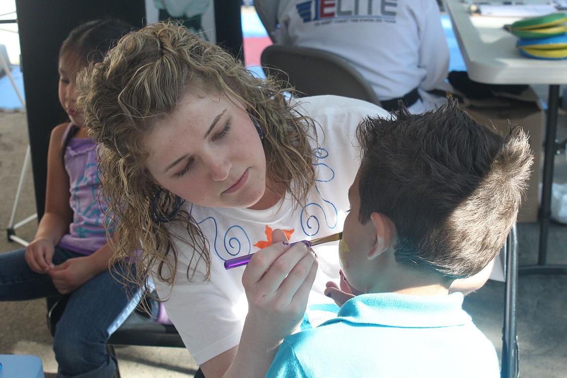 A young Camas Days patron gets his face painted at the Under the Sea Dentistry for Children booth.