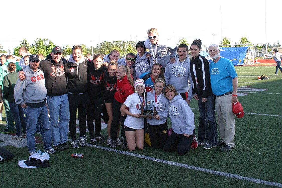 The Camas track team poises with its fourth-place trophy from the state meet.