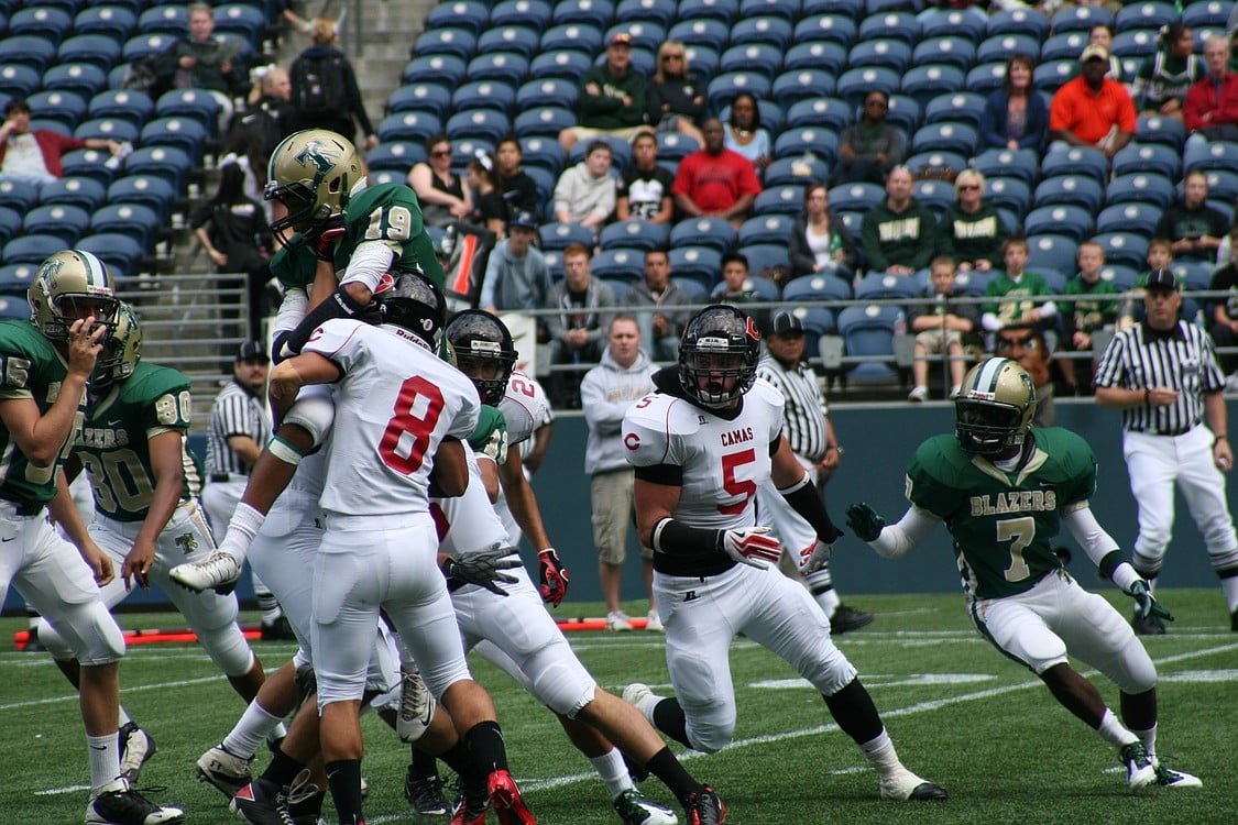 Miguel Salamanca (8) and two other Camas defenders take the Timberline kick returner off his feet.