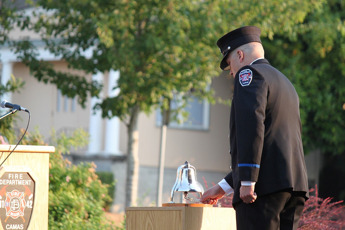 Camas Firefighter/Paramedica Chris Richardson rings the bell during the event memorializing the Sept. 11, 2011 terrorist attacks. The bell was run first 3 times, then four times, then three times again, to recognize the 343 firefighters who died in New York City and Washington D.C. on that day.