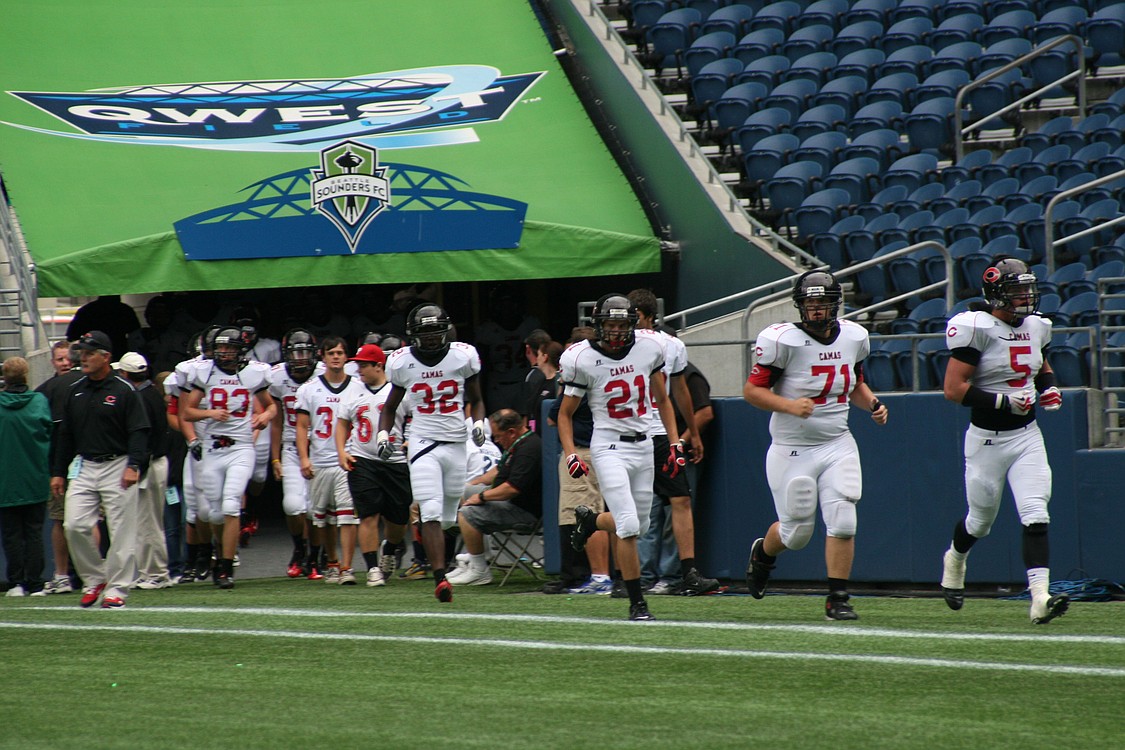 The Papermaker football players run out of the Qwest Field tunnel to begin the second half.