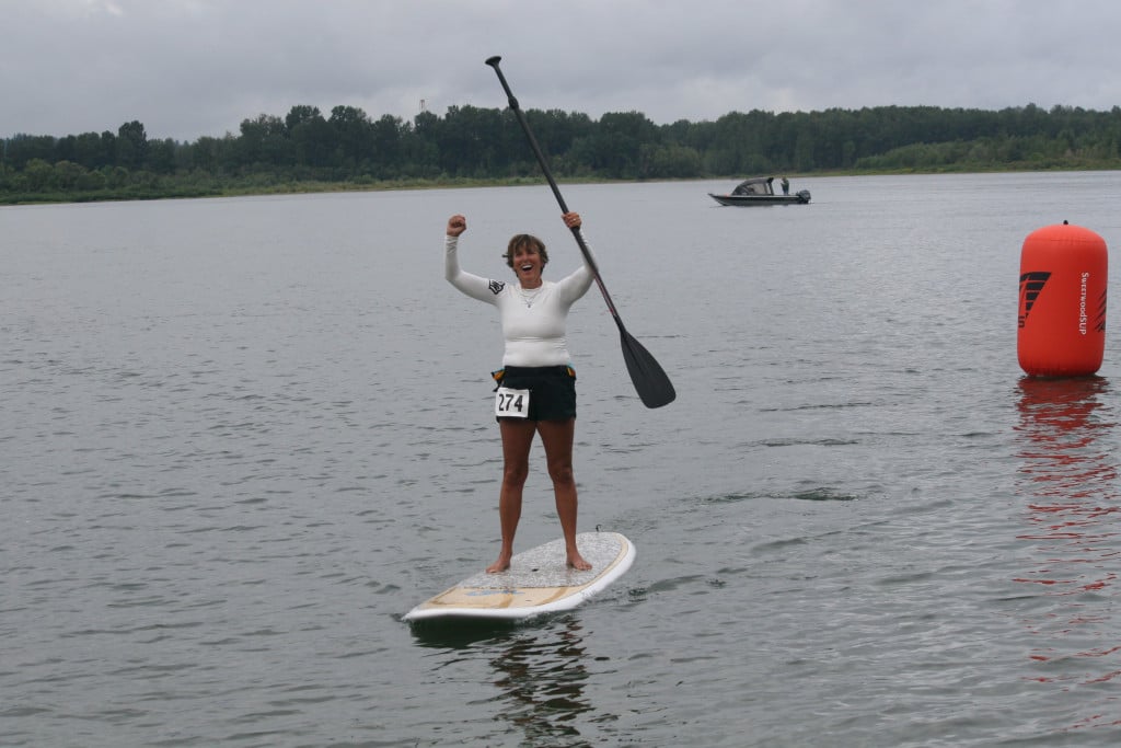 Pam Ensley pumps her fists in the air after finishing the 2-mile novice course challenge Sunday, in Washougal.