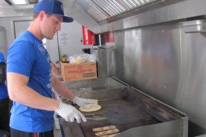 Adam Barlas prepares an order at Getta Gyro. The new food truck is a regular staple at the Vancouver Farmer's Market at Columbia Tech Center. He is assisted by mom, Elayne and dad, Harry. The Barlas family are Camas residents. 