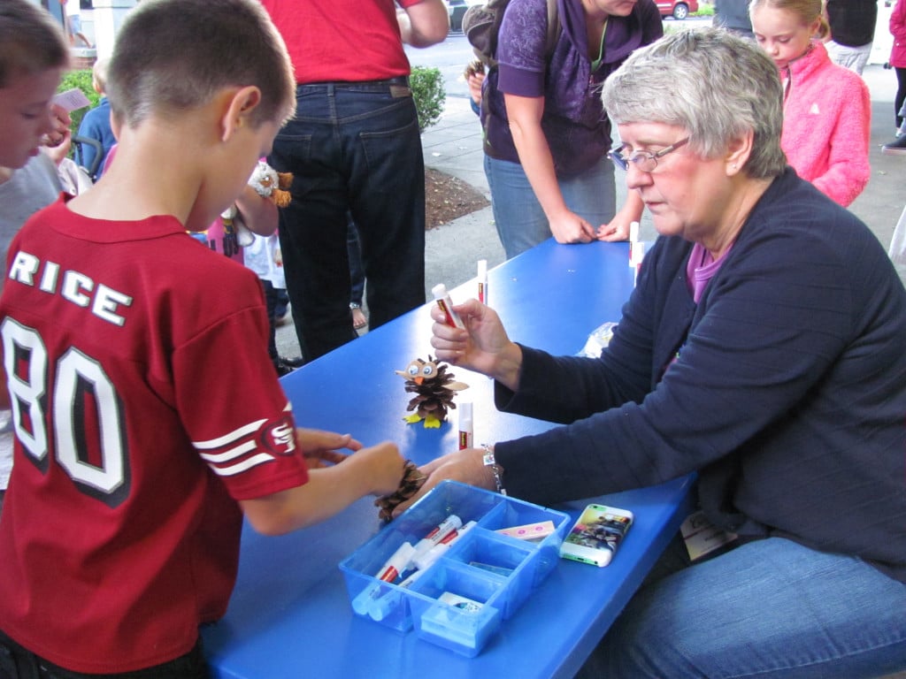 Kathy Marlowe helped children create pine cone owls, during First Friday. "Our volunteers bring a fun vibe and add extra helpfulness for the people attending," said Downtown Camas Association Executive Director Carrie Schulstad.  