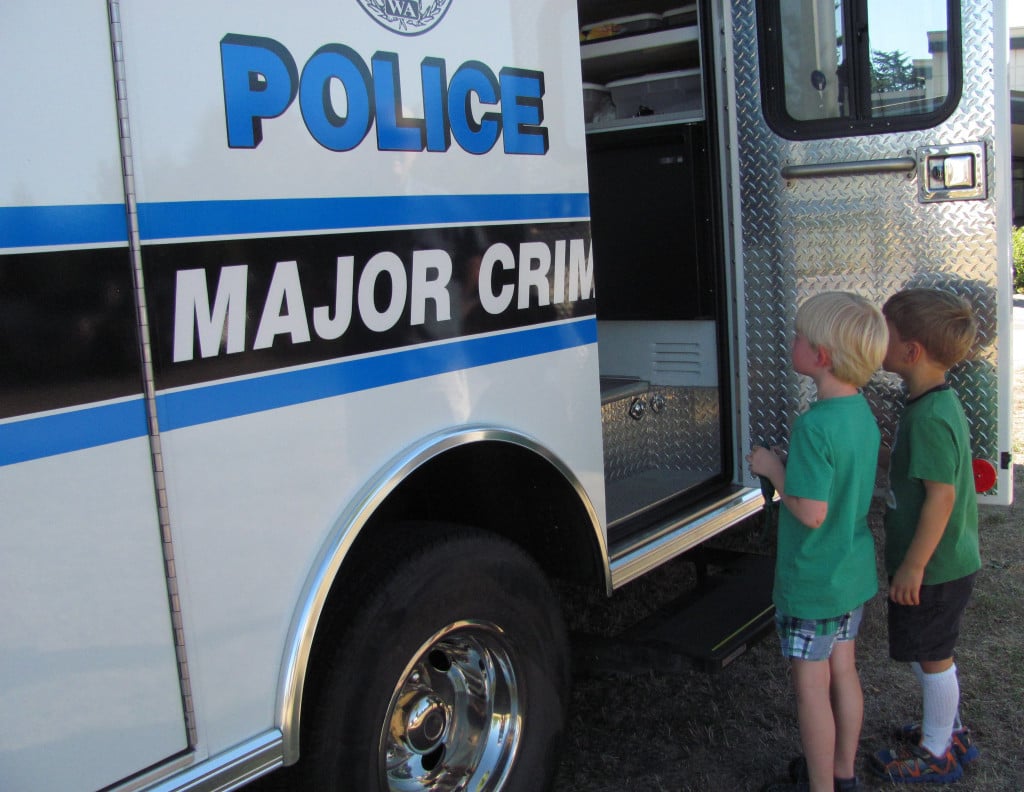 Four-year-old Torbjorn Swanson from Washougal and his friend, 5-year-old Robert Romito from Vancouver, inspect a crime investigation van during the Girl Cops Are Awesome event. 