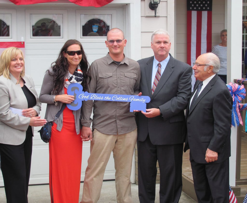 Stacey Dodson, U.S. Bank president in Oregon and Washington, Katie and Corey Collins, Thomas Kilgannon, president of the Freedom Alliance and Joe Badalamenti, CEO of Five Brothers, celebrate the completion of the Collins' newly renovated, mortgage-free home. 