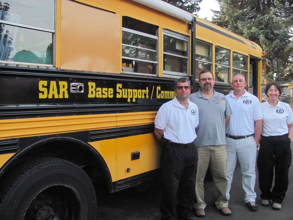 From left, Rick Blevins, Stephen Donahay, Wade Oxford and Jan Foltz enjoy their work as volunteers with Silver Star Search and Rescue. Blevins converted this old school bus into a mobile operations center. 