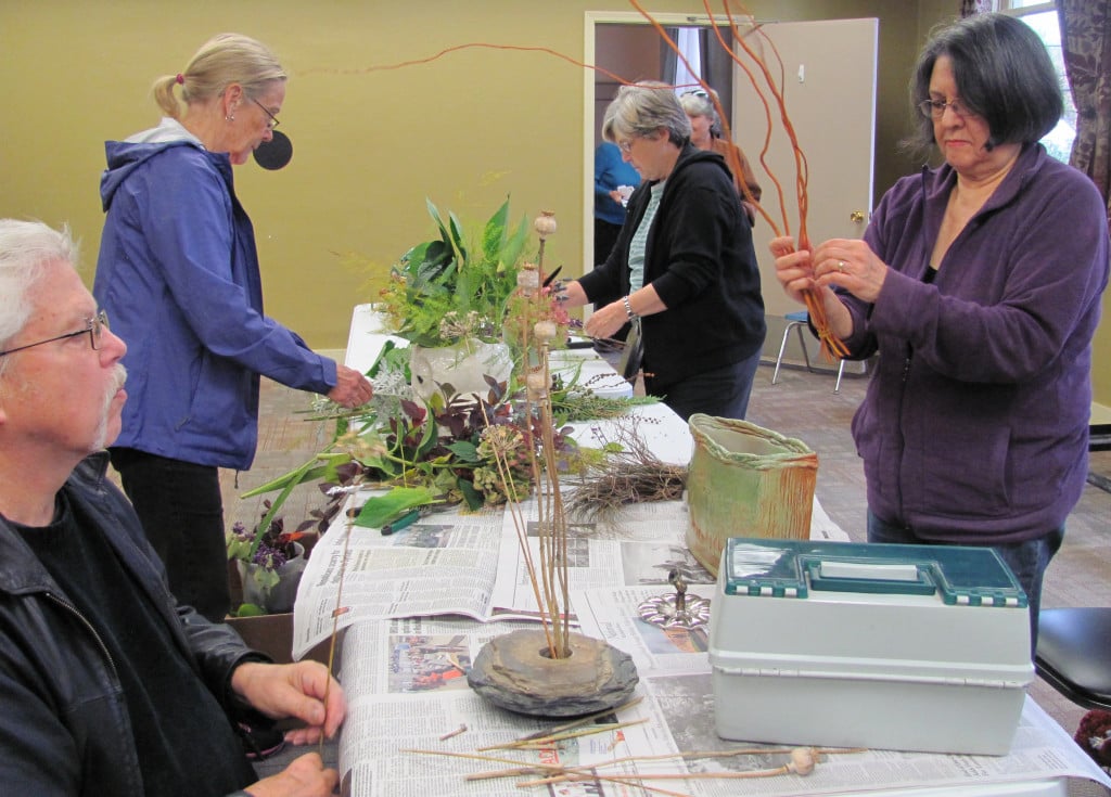 Garden club members trade ideas as they work on holiday themed centerpieces. Other upcoming opportunities to get creative for the holidays will be happening this weekend.                                