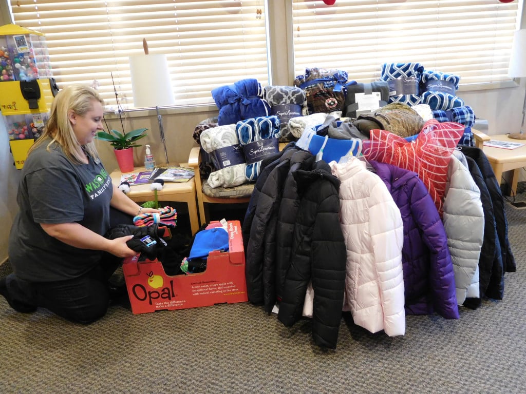Shantelle Arney organizes donations made to Washougal Family Dental. The coats, gloves, hats and blankets will be given to local homeless people.            