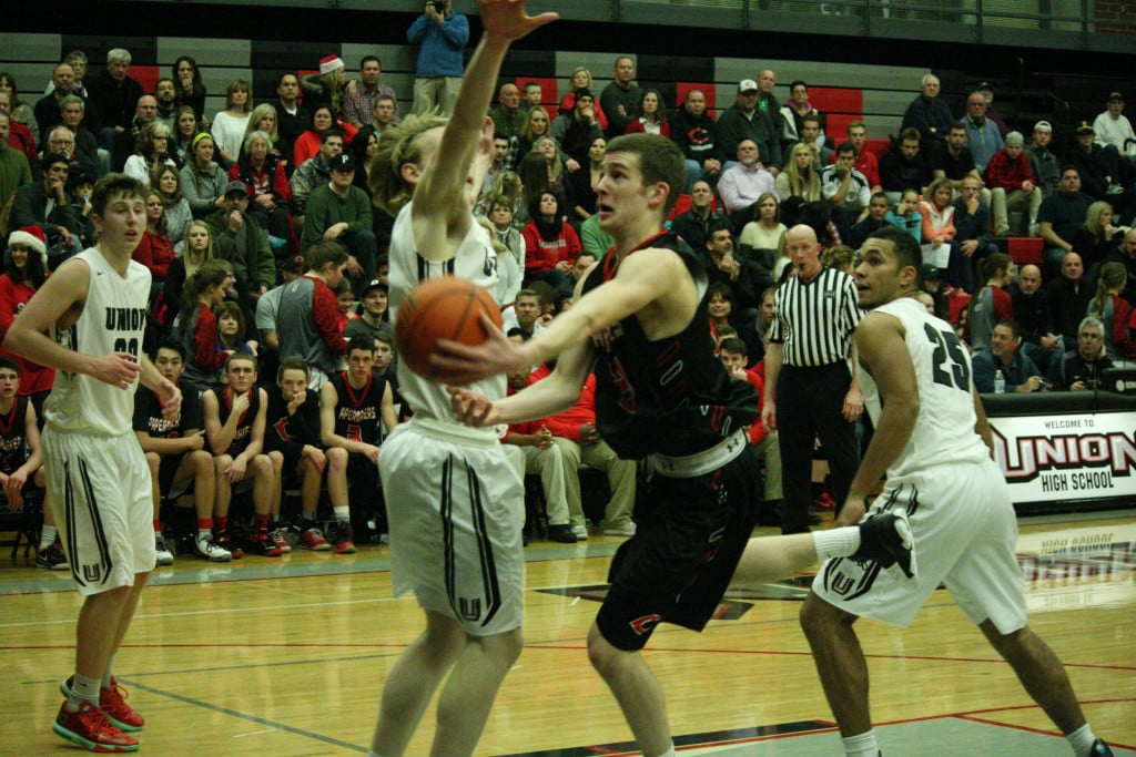 Alex Glikbarg curls around a defender and scores two points for Camas Friday, at Union High School. The Titans unravelled the Papermakers 76-55.
