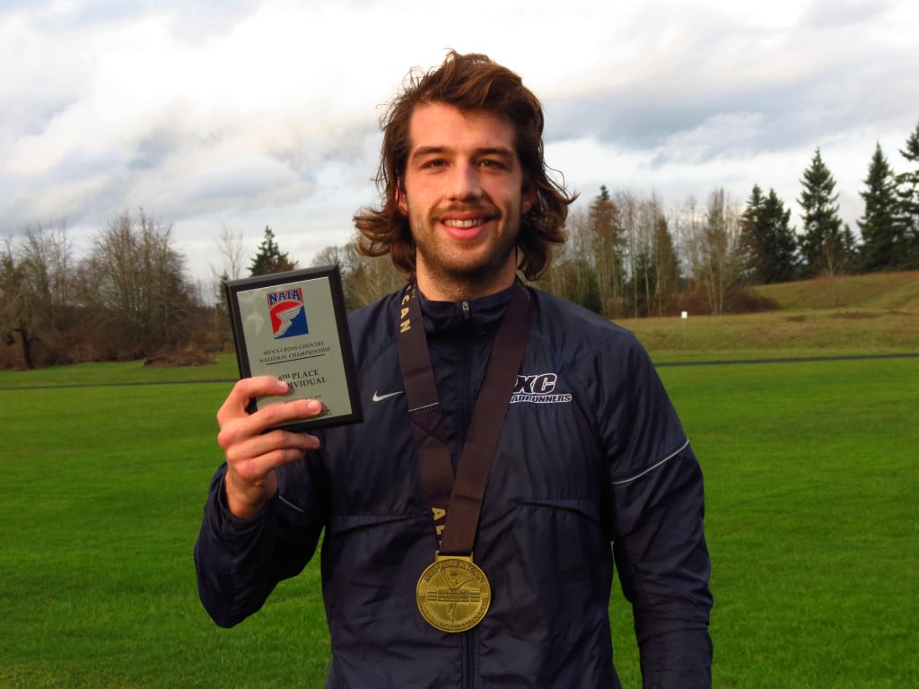 Spencer Head shows off his eighth place plaque and All-American medal earned at the NAIA Cross Country National Championship. The 25-year-old from Camas runs for Dalton State College, in Dalton, Georgia.