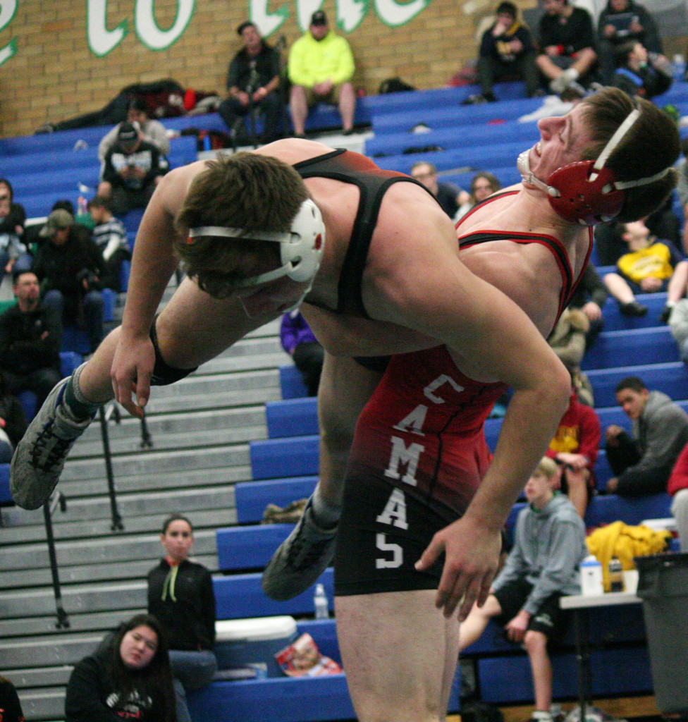Camas wrestler Sam Malychewski takes Jeff Dunagan, of Dallas, Oregon, for a ride in the 170-pound consolation finals of the Pacific Coast tournament. Dunagan held on to a 4-2 victory, and Malychewski settled for fourth place.