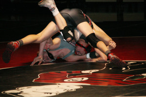 Freshman Papermaker Jack Latimer rolls up Noah Talavera, of Union, on the wrestling mat Wednesday, at Camas High School. Latimer won 10-5. The Papermakers lost to the Titans, but turned around and captured first place at the Bearcat Invitational Saturday. (Dan Trujillo/Post-Record)