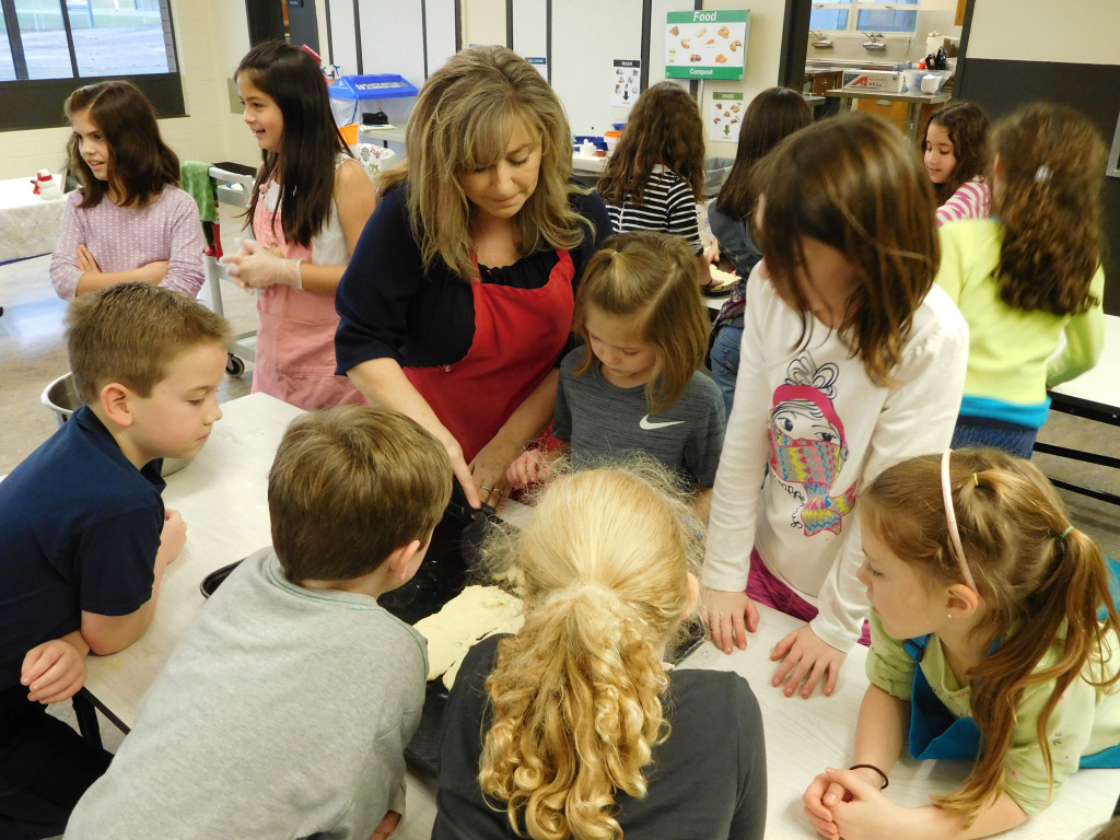 Instructor Julie Werner shows young participants how to roll out dough during the Chefs in Training class offered through Camas Community Education. Werner has been teaching the course for four years.