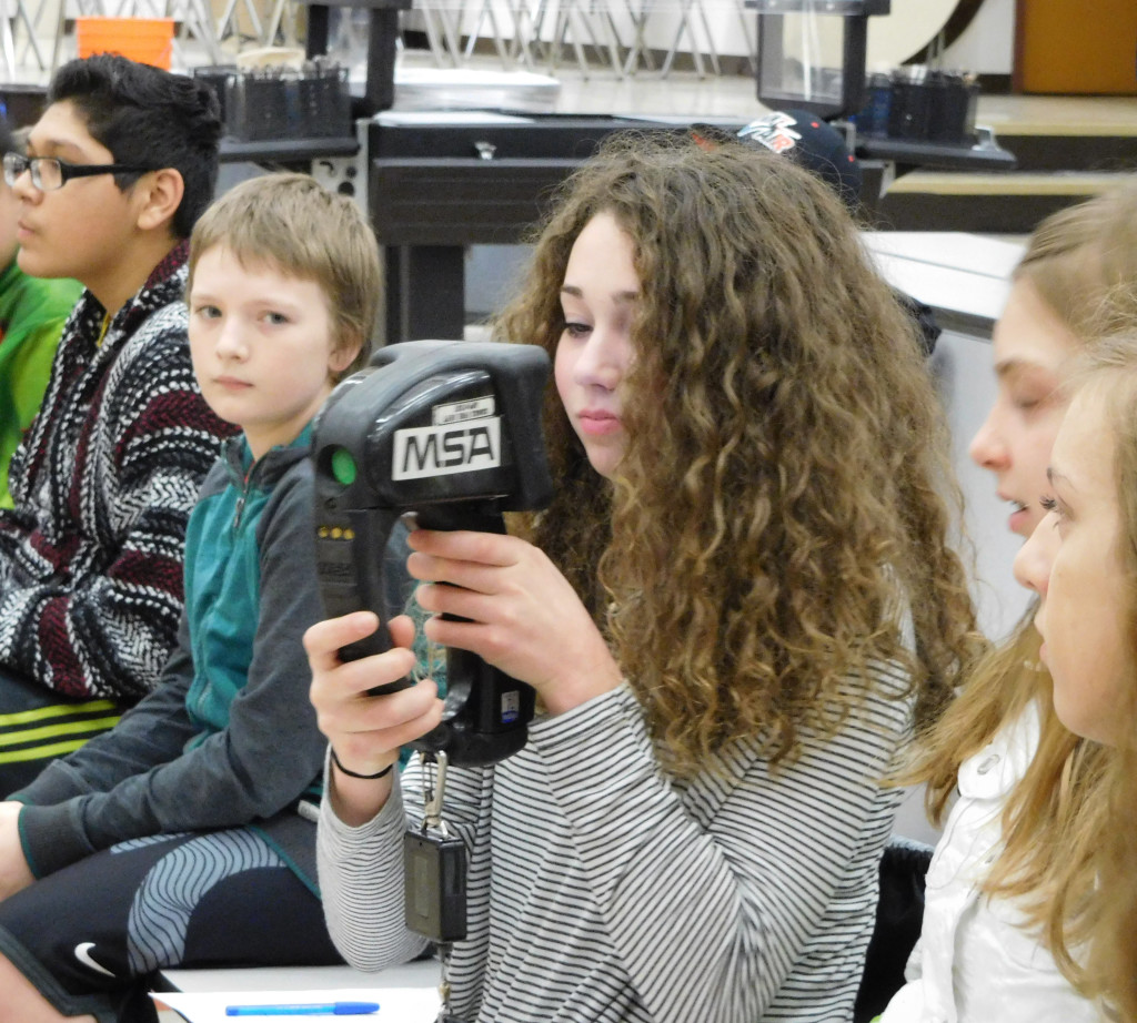 Students inspect a thermal imaging camera during career day at Jemtegaard Middle School.