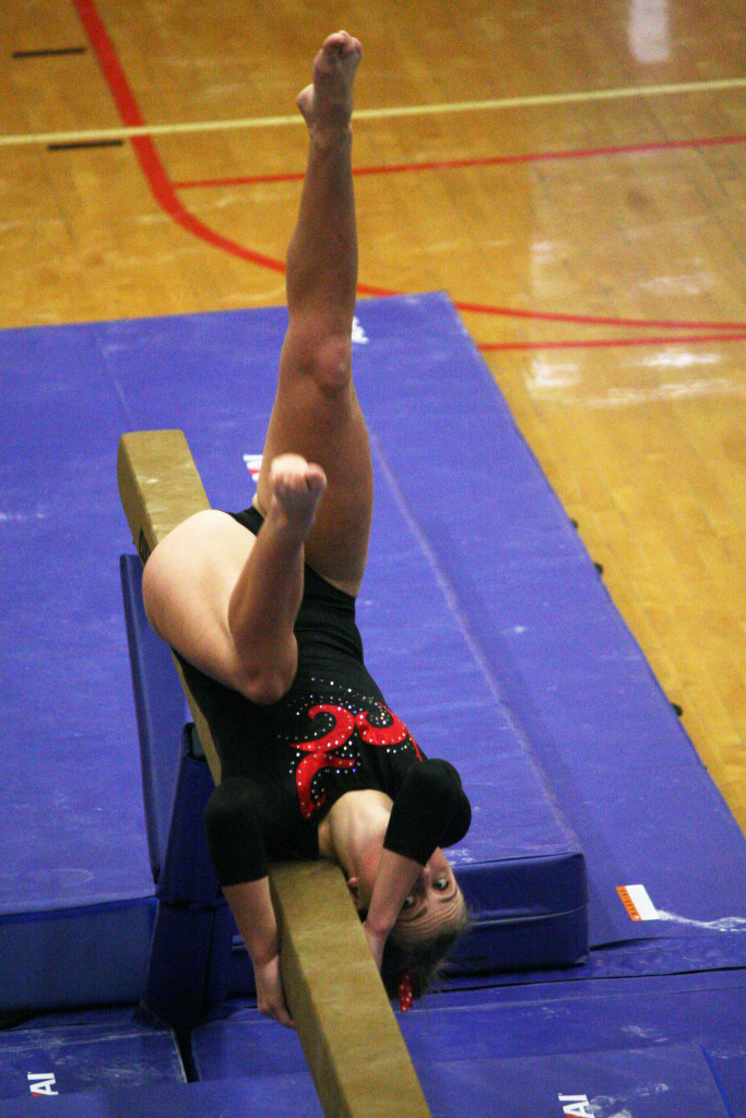 Caleigh Lofstead, the 4A Greater St. Helens League Gymnast of the Year, begins her trademark roll on the balance beam. The Camas High School senior finished in fourth place in the all-around competition.