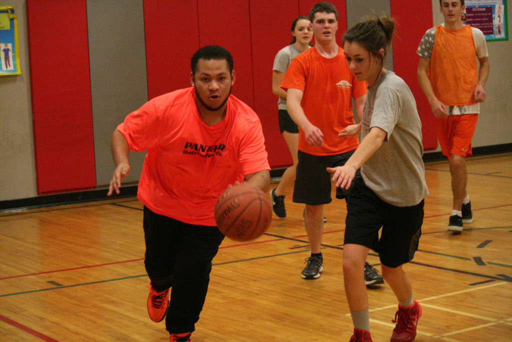 Andrew Valenzuela drives to the basket with Abby Young. Behind them are fellow Unified team members Cameron Dayley, Jessie Larson and Kyle Hoesly.