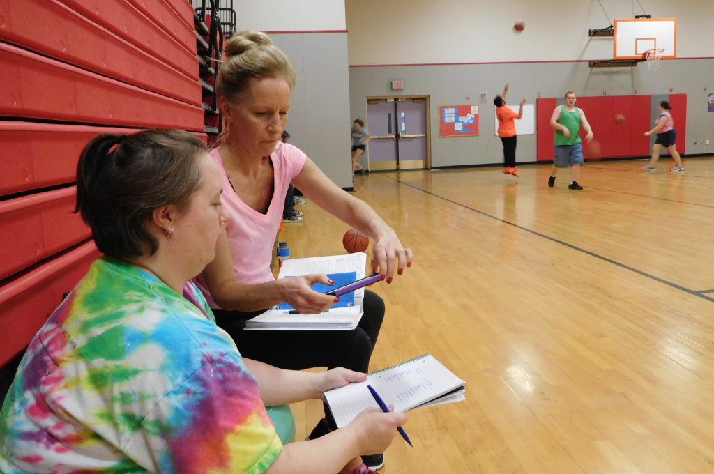WHS Unified Basketball Team head coach Dani Allen (left) confers with assistant coach Lin Guiles during a recent practice at Hathaway Elementary School. 