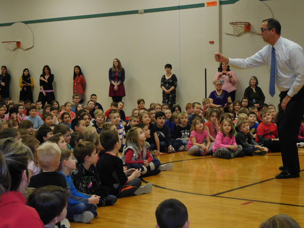 Washougal School District Superintendent Mike Stromme leads students in a school cheer.
