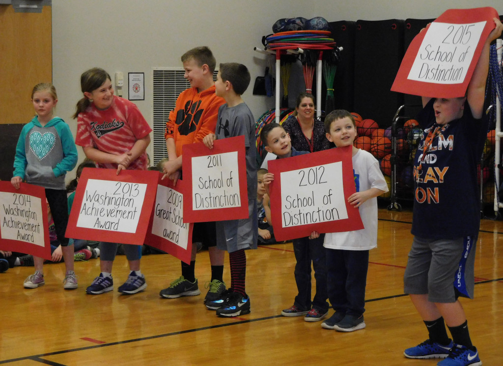 Cape Horn-Skye students hold up signs representing the number of times the school has been named a statewide School of Distinction during an assembly last week. 