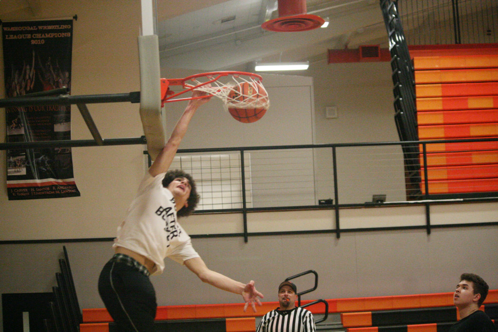 Matt Rotundo throws down a dunk during the Washougal High School seniors  and alumni basketball game Friday. 